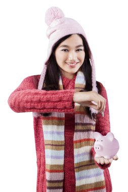 Schoolgirl with piggy bank