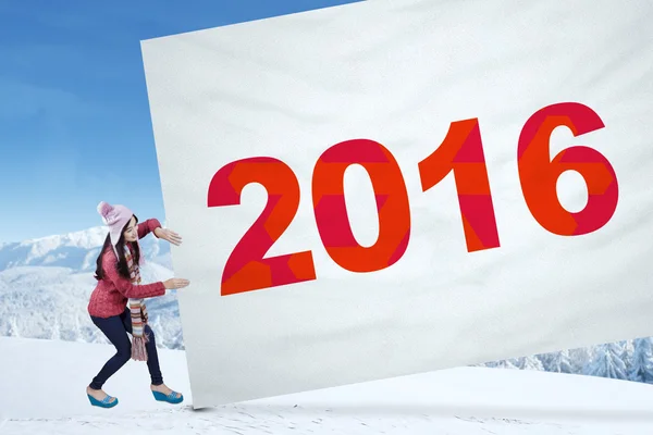 Young girl pulls banner with numbers 2016 — Stock Photo, Image