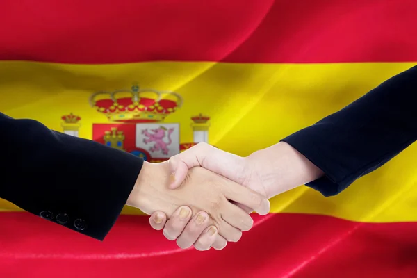Рукопожатие с флагом Испании — стоковое фото