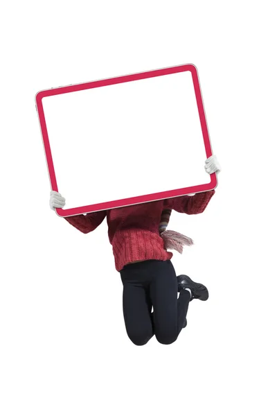 Woman jumping in studio with empty board — Stock Photo, Image