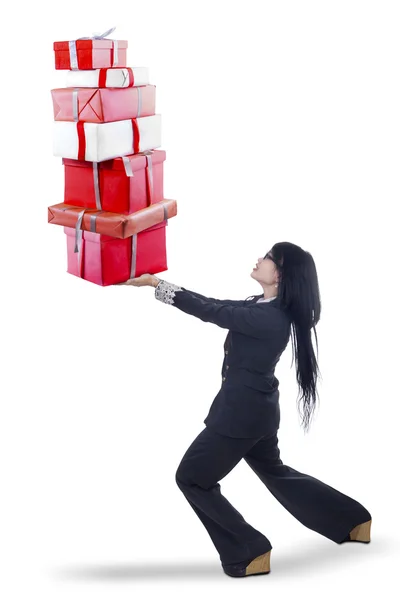 Businesswoman carrying christmas gifts Royalty Free Stock Photos