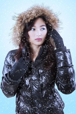 Gorgeous girl wearing jacket with snowfall