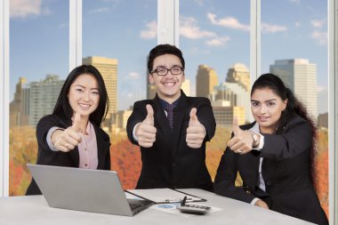 Group of multi ethnic workers show thumbs up
