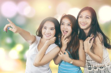 Impressed girls looking at copy space