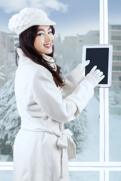 Girl using digital tablet near the window — ストック写真