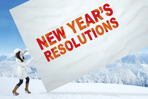 Girl with winter coat and a resolution banner — Stockfoto