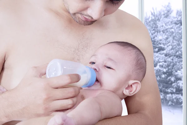 Man giving milk on his baby — Stok fotoğraf