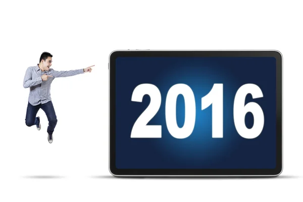 Young worker pointing at numbers 2016 — Stock Photo, Image