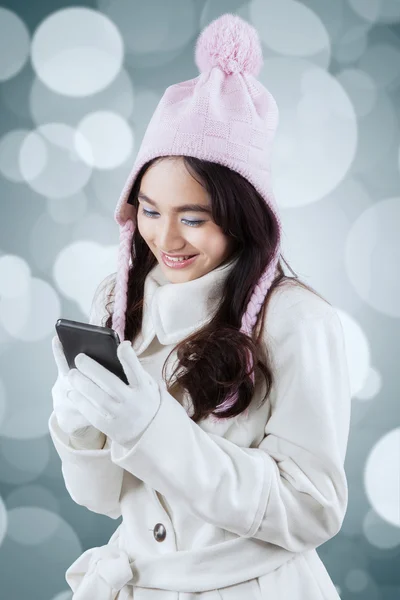 Lovely woman sending message with cell phone — Stock Photo, Image