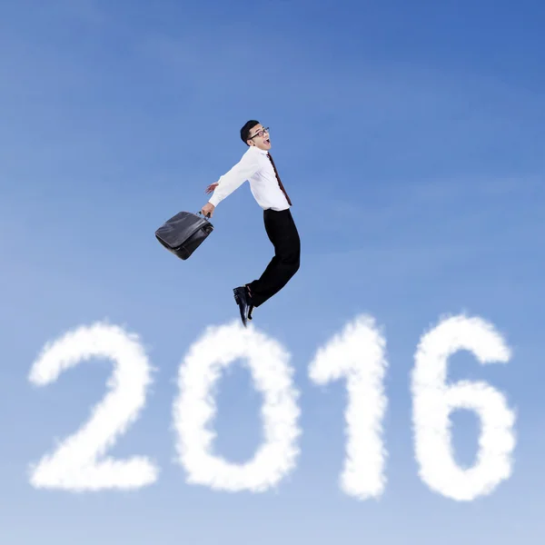 Male worker jumping above numbers 2016 — Stock Photo, Image