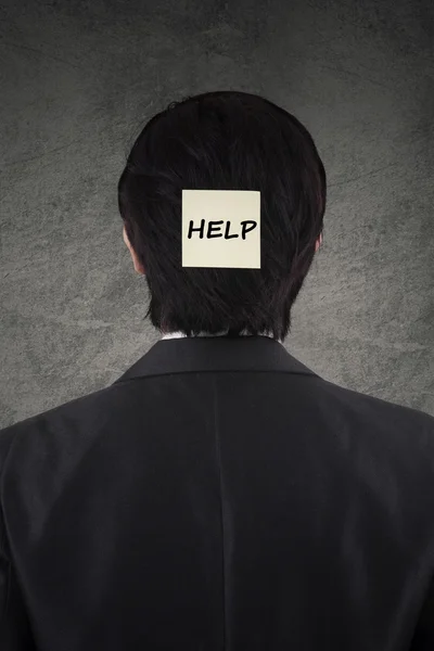 Male worker with a help text on head — Stock Photo, Image