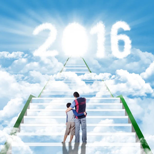 Man and his son on the stairs with numbers 2016 — Stock Photo, Image