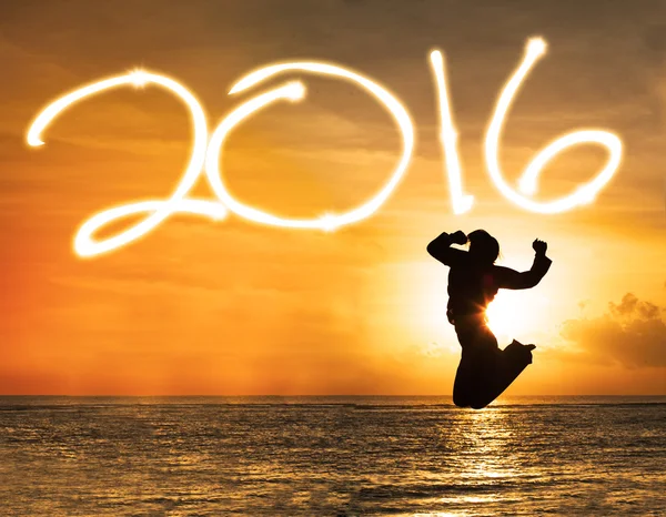 Silhouette of woman jumping under numbers 2016 — Stock Photo, Image