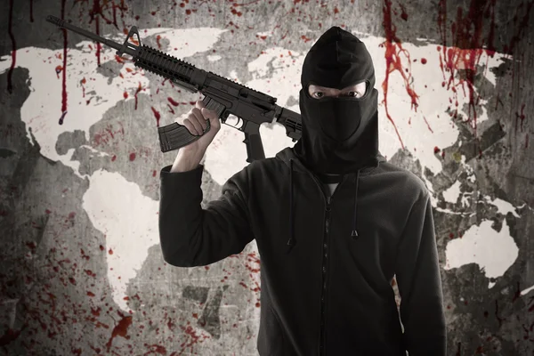 Jihadist holds rifle with bloody map — Stock Photo, Image