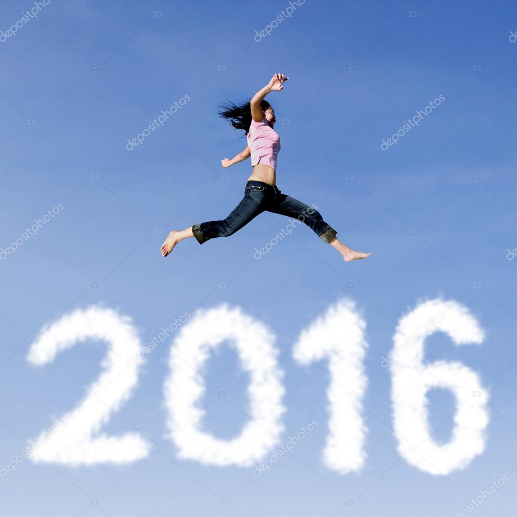 Joyful woman leaps above numbers 2016