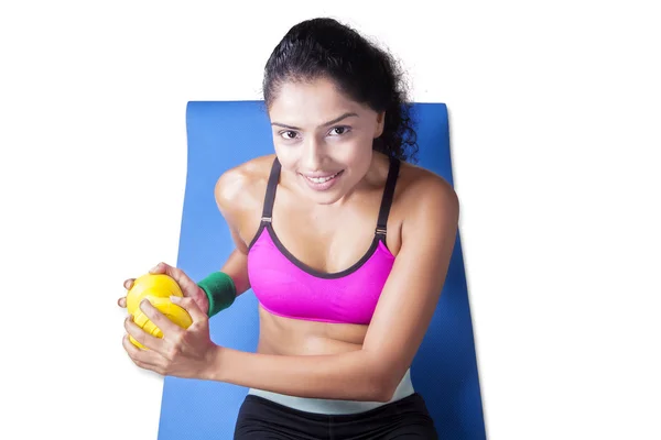 Closeup of woman lifting dumbbell on mattress — Stock Photo, Image