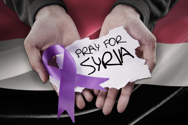 Hands with ribbon and pray for Syria