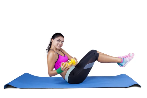 Sporty woman workout on mattress with barbell — Stock Photo, Image
