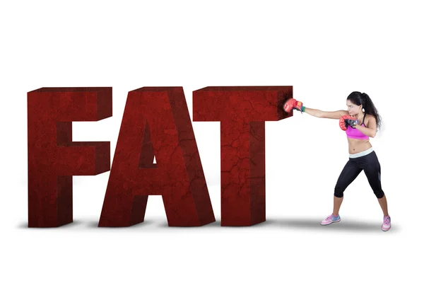 Woman punching a fat text with boxing gloves — Stock Photo, Image