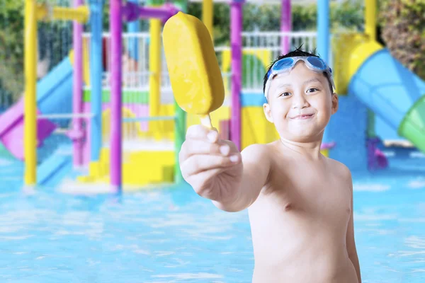 Niño mostrando helado en la piscina — Foto de Stock