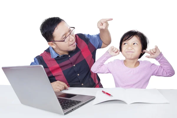 Little girl closing her ears when scolded by her dad — Stock Photo, Image