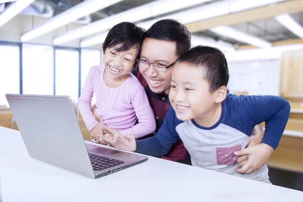 Teacher and students having fun with laptop — Stock Photo, Image