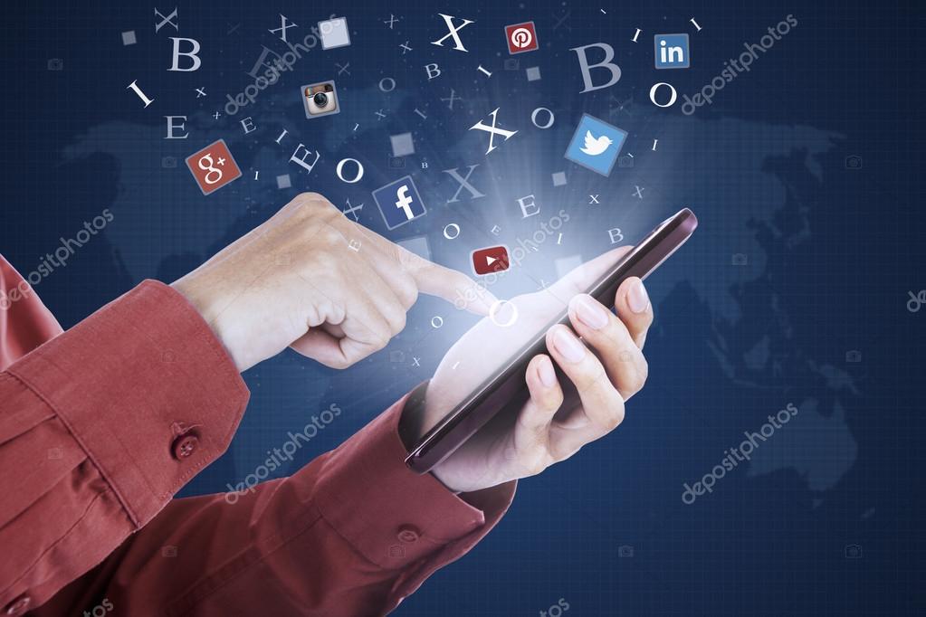 JAKARTA, SEPTEMBER 21, 2015: Closeup of businessman hands using social media apps on the mobile phone