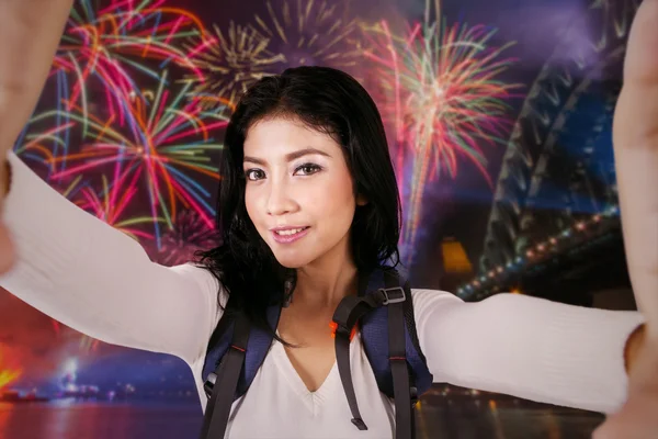 Mochilera femenina tomando selfie en fiesta de fuegos artificiales — Foto de Stock