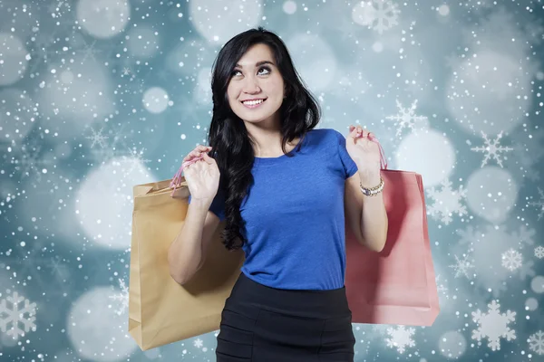 Excited female shopper with winter background — Stock Photo, Image