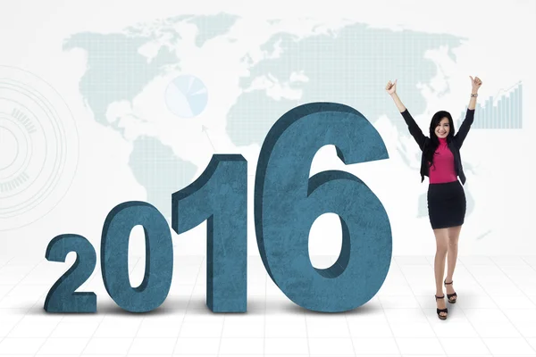 Happy businesswoman with numbers 2016 and map — Stock Photo, Image