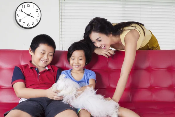 Bambini e madre giocare a cane — Foto Stock