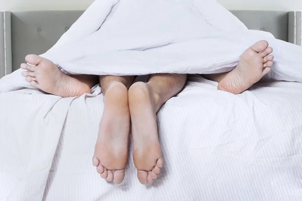 Couple feet sleep together on bed — Stock Photo, Image