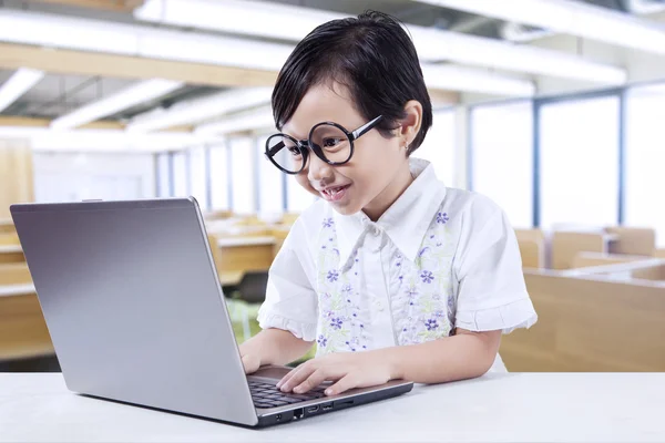 Girl wearing Glasses while using Laptop — Stock Photo, Image