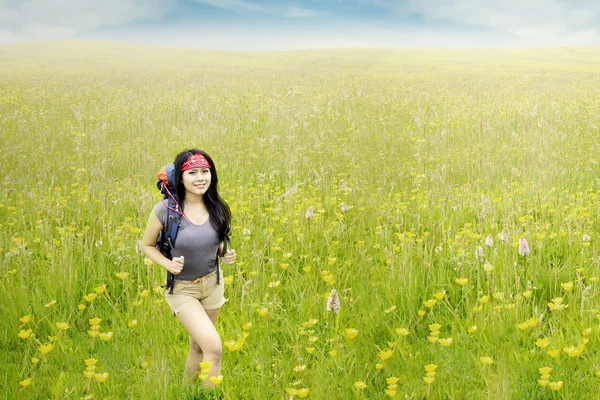 Cheerful hiker walking on meadow — Stock Photo, Image