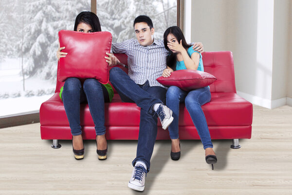 Three teenagers watching TV
