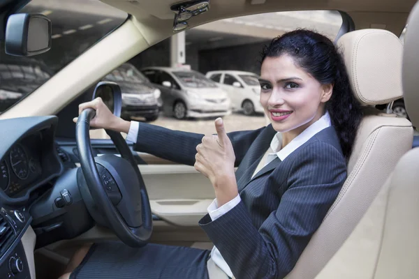 Indian woman shows thumb up in new car — Stock Photo, Image