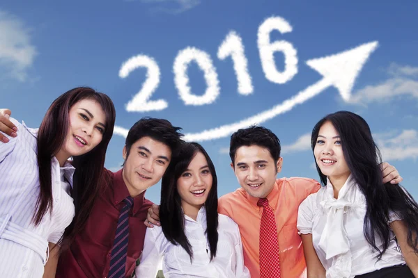 Happy young workers under number 2016 — Stock Photo, Image