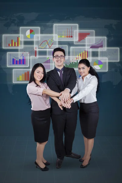 Workers and financial graph joining hands — Stock Photo, Image