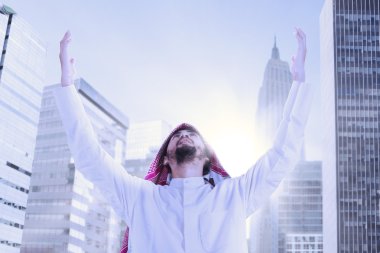 Arabic businessman praying outdoors