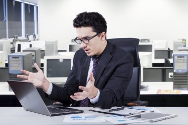 Businessman looks shocked and disappointed