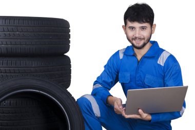 Mechanic with laptop and tires