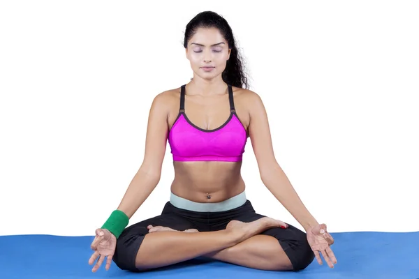 Pretty woman with sportswear meditating — Stockfoto