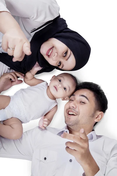 Happy parents and cute baby lying in studio — Stok Foto