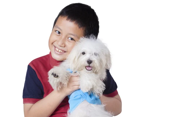 Fröhlicher Junge umarmt seinen Hund im Studio — Stockfoto