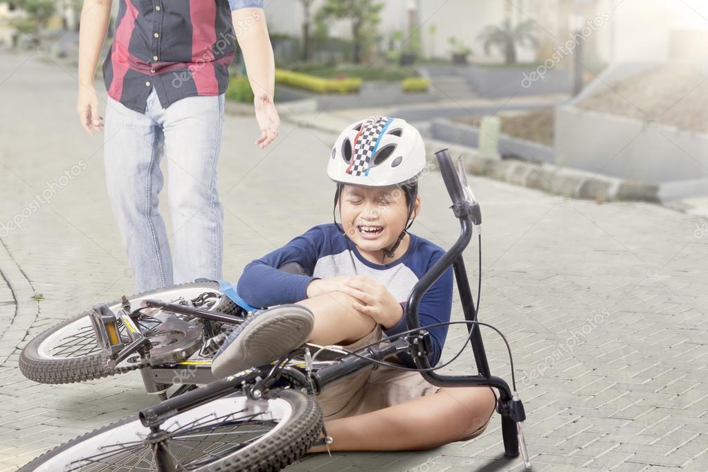 Kid gets accident with his bike and crying Stock Photo by ©realinemedia