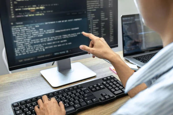 Programmer Team of  Developing programming and website working in a software develop company office, writing codes and typing data code, Programming with HTML, PHP and javascript.