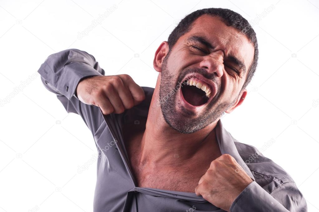 man screaming and ripping his shirt