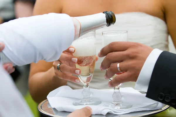 Bottle of champagne pooring in to glasses Royalty Free Stock Photos