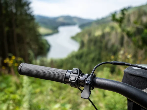 Dettaglio manubrio e-bike con pulsante di velocità. Paesaggio sfocato sullo sfondo. — Foto Stock