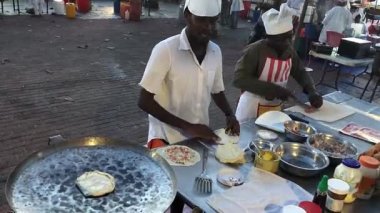 Stones Town, ZANZIBAR, 20 Şubat 2020 - Erkekler pazarda Zanzibar pizzası hazırlıyor